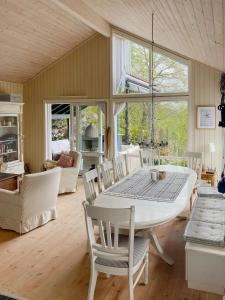 a dining room with a white table and chairs at Cozy Cabin With Økstrafjord View in Jelsa +27 photos