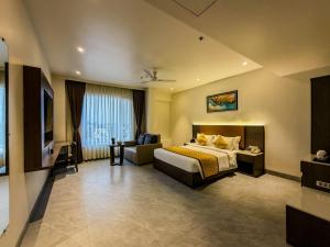 a hotel room with a bed and a couch at ZiP By Spree Hotels Pandharpur in Pandharpur
