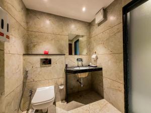 a bathroom with a toilet and a sink at ZiP By Spree Hotels Pandharpur in Pandharpur +56 photos