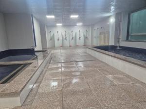 a room with a row of urinals in a bathroom at 광장관광호텔 in Pusan