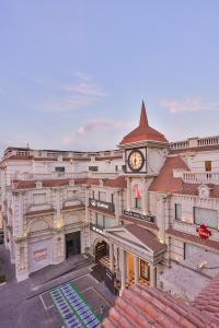 a large building with a clock tower on top of it at Avari Boutique Gujranwala in Fattu Mand