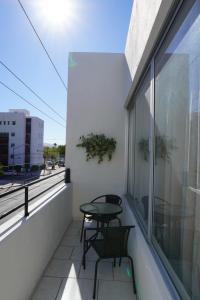 a balcony with two chairs and a table on it at Departamento zona central in La Paz