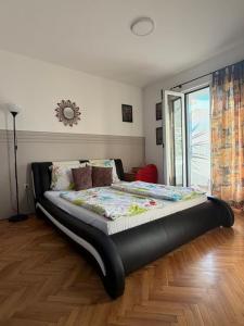 a large bed sitting in a room with at Apartmani Tamara in Tivat