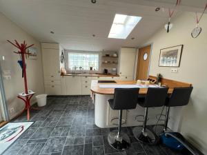 a kitchen with a island in the middle of a room at Trädgårdscafé Pedalen B&B in Halmstad