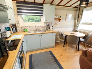 a kitchen and dining room with a table and chairs at Moggs Retreat in Skegness