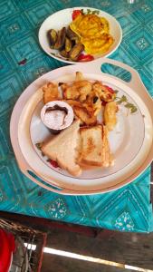 a plate of food on a table with breakfast foods at Adefiro Homestay in Besir +48 photos