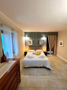 a large bedroom with a large bed and a bathroom at Cascina Canale in Sabbio Chiese