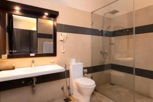 a bathroom with a toilet and a sink and a shower at Oak Ray City Hotel in Kandy +36 photos