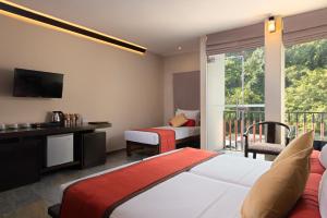 a hotel room with a bed and a balcony at Oak Ray City Hotel in Kandy