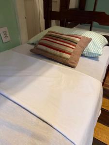 two beds with white sheets and a blanket at Sobrado Antonieta in Belém +6 photos