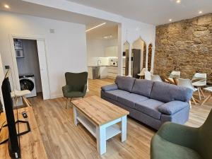 a living room with a couch and a table at Apartamento Plaza de Armas 2 in Ferrol +21 photos