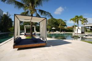 a swing by the pool at a resort at Pronoia Beach Resort in Jimbaran