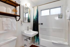 a white bathroom with a sink and a shower at 2583-Bernhardt Brown Bungalow in Big Bear City +21 photos