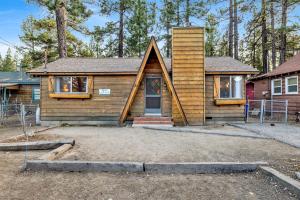 a home with a wooden house with a porch at 2583-Bernhardt Brown Bungalow in Big Bear City