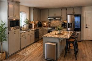 a kitchen with gray cabinets and a large island at Spacious Ranch Retreat Near Yosemite & Bass Lake with Hot Tub & Game Room in Oakhurst