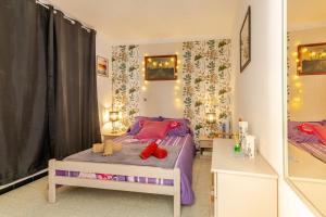a bedroom with a bed with red shoes on it at Appart cathare et l'olivier in Tautavel