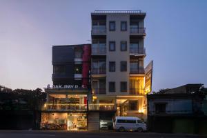a white van parked in front of a building at Oak Ray City Hotel in Kandy