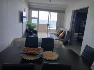a dining room with a table and a view of the ocean at Blue Largo Sea View in Westbrook