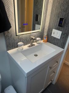 a bathroom with a white sink and a mirror at You Deserve the Best! in Tacoma +24 photos