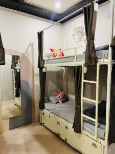 a couple of bunk beds in a room at Yovibe Stays, Dorms & Rooms, Assi Ghat, Varanasi in Varanasi +38 photos