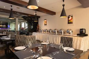 a dining room with tables and chairs in a restaurant at Oak Ray City Hotel in Kandy