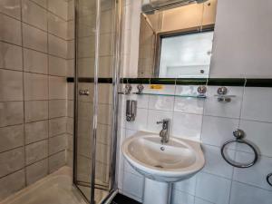 a bathroom with a sink and a shower at The Forest- Mosswood in Cambridge