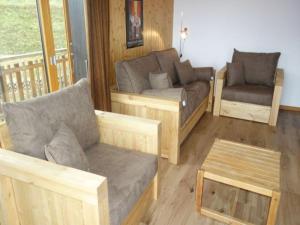 a living room with a couch and a chair at Apartment in Veysonnaz near Ski Gondola in Veysonnaz