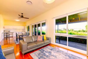 a living room with a couch and a large window at Tranquil Vale Vineyard in Luskintyre