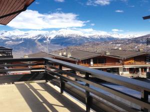 a view from the balcony of a building with snow covered mountains at Apartment in Veysonnaz near Ski Gondola in Veysonnaz