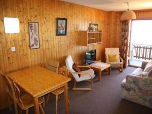 a living room with a table and a couch at Apartment in Veysonnaz near Ski Gondola in Veysonnaz