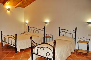 a bedroom with two beds in a room at Li Teggi Turismo Rurale in San Teodoro +26 photos
