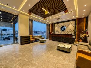 a lobby with a waiting room with a statue at ZiP By Spree Hotels Pandharpur in Pandharpur