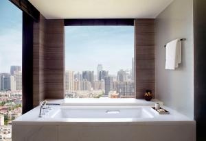 a bath tub in a bathroom with a large window at The Ritz-Carlton, Xi'an in Xi'an