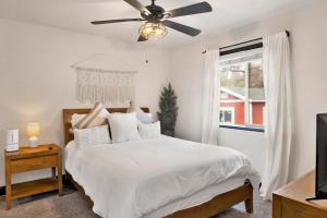 a white bedroom with a bed and a ceiling fan at 2614 - Cielos Nest in Big Bear Lake