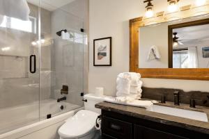 a bathroom with a toilet and a sink and a mirror at 2614 - Cielos Nest in Big Bear Lake +22 photos