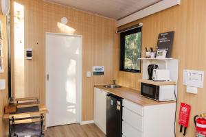 a kitchen with a counter and a microwave at Wilderness Whisper 1770 By Tiny Away in Agnes Water +21 photos