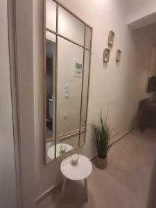 a room with a mirror and a small table at Lemmy Аpartment in Ofrínion +3 photos
