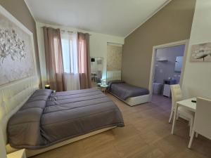a bedroom with a large bed and a table and a desk at La Suite Di Segesta in Calatafimi +92 photos