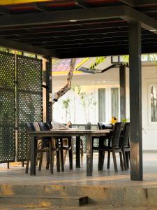a wooden table and chairs on a patio at SRK luxe resort in Maivādi Road
