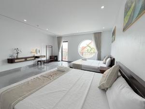 a large white bedroom with two beds and a window at Honeybee Villa in Văn Lâm +143 photos