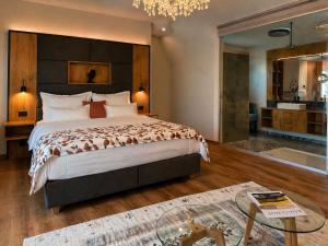 a bedroom with a large bed and a bath tub at KOASA HOF Bed and Breakfast in Oberhaag +35 photos