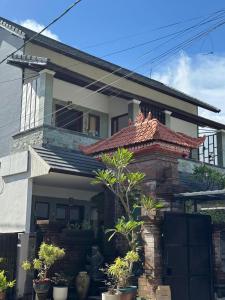 a brick house with a porch with plants on it at Holi Saren Guest House in Nusa Dua