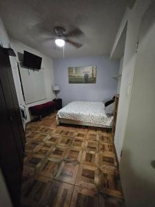 a bedroom with a bed and a wooden floor at Villas Serena Rosarito in Rosarito Beach +12 photos