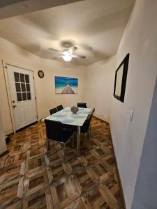 a dining room with a table and some chairs at Villas Serena Rosarito in Rosarito Beach