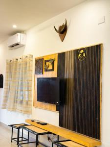 a room with a table and a tv on a wall at SRK luxe resort in Maivādi Road