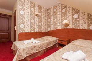 Postel nebo postele na pokoji v ubytování Bałtyk Resort