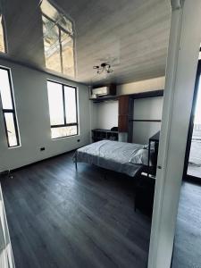 a bedroom with a bed and two windows at Casa Campamento in La Cueva