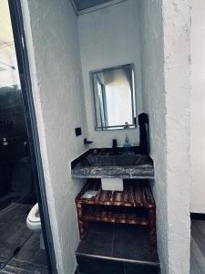 a bathroom with a sink and a mirror at Casa Campamento in La Cueva +10 photos