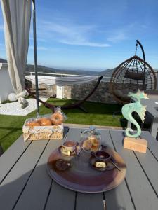 a tray of food on a table on a deck at Umbertos Rooms in Jerzu