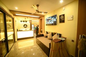 a living room with a couch and a table at Eloras Inn in Siliguri +17 photos
